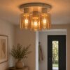 Brilliant Leuchten Plafonnier Lyska avec 3 abat-jour cylindriques en verre ambré